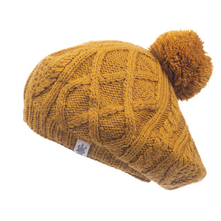 A mustard Yves Beret with a pom pom, handmade in Nepal.