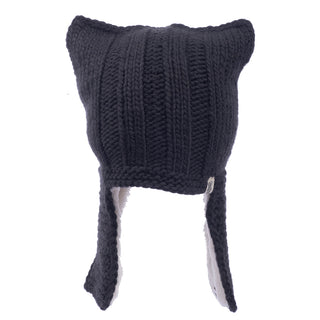 A handmade black woolen hat with ear flaps, styled like an Illyrian helmet earflap.