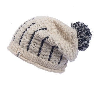 A cream-colored Ferry slouch knitted beanie with black stripes and a pom-pom on a white background.