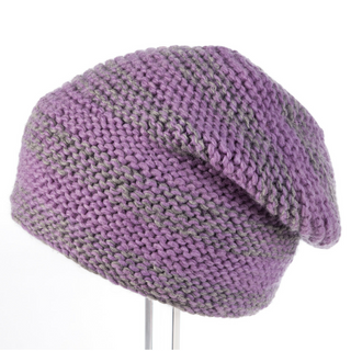 A Soft Stripe Slouch beanie on a stand.