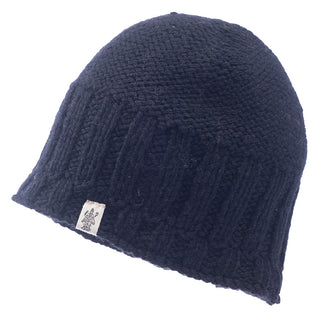 A black merino wool knitted Percy beanie on a white background.