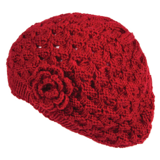 A red crocheted Say It With a Rose Beret with a flower detail on the side, made from Merino Wool.
