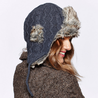 A woman wearing a Cable Knit Russian Hat with Faux Fur hood.