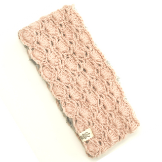 A Lacey headband with a sherpa lining and a cable pattern on a white background.