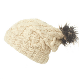 A Sugar Sugar Slouch merino wool knitted beanie with a faux fur pom pom.