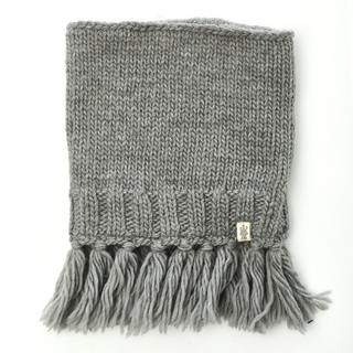 A gray Sweet Emotions Neckwarmer with a sherpa fleece lining, featuring a ribbed design and tassel details displayed on a white background.