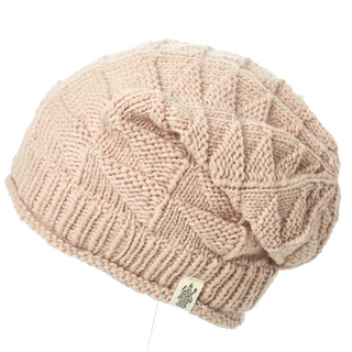 An organic cotton Wave Slouch pink knit beanie on a mannequin.