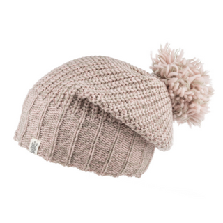 A beige knitted Union Slouch hat, handmade in Nepal, with a ribbed design and a fluffy pompom on top.
