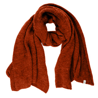 The Air Wrap Scarf, a thick handknit merino wool accessory in solid rust-red, is displayed flat on a white background with one end looped over the other.