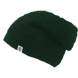 The Boho Slouch is a dark green knitted wool beanie with a ribbed brim and a small rectangular white logo tag, shown on a plain white background—a perfect winter hat.