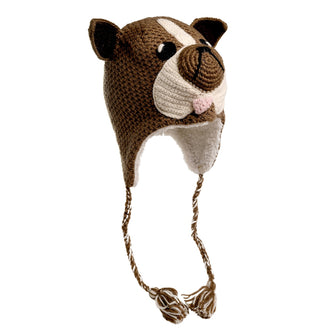 The Crochet Bulldog Hat, handmade in Nepal, is designed to resemble a dog's head. This hat is predominantly brown with white and black accents and features pointy ears, a black nose, and black eyes. It includes braided tassels hanging from the ear flaps and has a cozy sherpa lining for extra warmth.