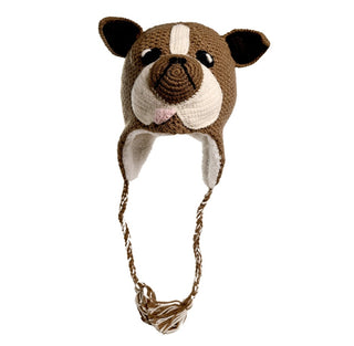 Introducing the Crochet Bulldog Hat: a handmade knitted hat from Nepal, designed to resemble a dog's face. It features floppy ears, black bead eyes, a black nose, and a pink tongue sticking out. Crafted from crochet wool with Sherpa lining for extra warmth, this brown hat is accented with white detailing and has braided strings on each side.