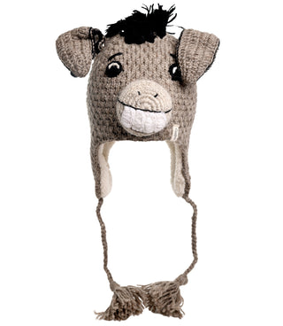 The Donkey Hat is a hand-crocheted gray hat that showcases a cheerful donkey face with embroidered eyes and ears, a tuft of black yarn hair on top, and braided tassels hanging from the ear flaps.