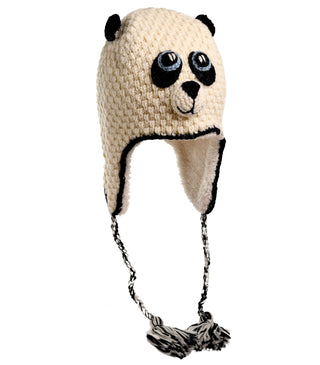 The Crochet Panda Hat is a hand-made accessory designed to resemble a panda, showcasing black eyes, ears, and a nose. Made from 100% wool, it features earflaps and braided tassels hanging from each side. The hat is predominantly white with black accents.