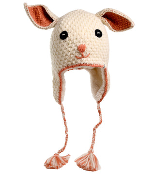 The Crochet Rabbit Hat is a white, handmade hat from Nepal featuring two large ears, earflaps with braided tassels, and a cute rabbit face with black eyes and a pink nose. The hat is adorned with crochet wool accents.