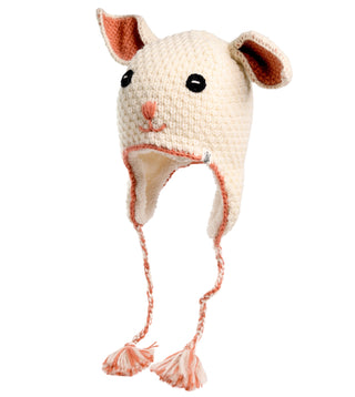 The Crochet Rabbit Hat is a white knitted hat made to resemble a rabbit's face, showcasing black eyes, a pink nose, and ears on top. Handmade in Nepal, it features ear flaps with pink and white tassels at the ends.