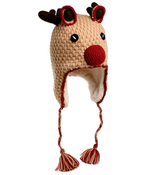 The Crochet Reindeer Hat is a beige knitted hat designed to resemble a reindeer's face, complete with antlers, a red nose, and ear flaps with braided tassels. Handmade in Nepal from crochet wool, it’s lined with cozy sherpa fabric for extra warmth.