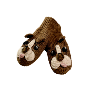 A pair of hand-made Crochet Bulldog Mittens from Nepal, knitted with brown wool and featuring crochet bulldog faces that include white snouts, black eyes, and pink tongues. These mittens have a ribbed cuff at the wrist and are displayed against a plain black background.