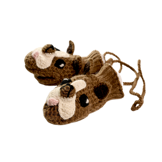 Introducing the Crochet Bulldog Mittens: a pair of brown animal puppet mittens designed to resemble dog heads, complete with white snouts, black eyes, and ears. Handcrafted in Nepal and linked by a brown knit string, the detailed crochet pattern adds a playful charm. Set against a black background, these mittens truly stand out.
