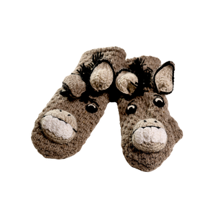 A whimsical pair of **Crochet Donkey Mittens**, featuring donkey faces complete with ears, eyes, nostrils, and smiling mouths with teeth. The charming handmade design from Nepal is set against a black background and includes sherpa lining for warmth and comfort.