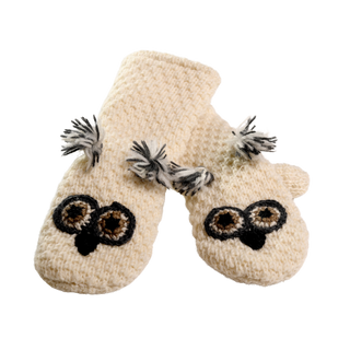 A pair of Crochet Owl Mittens, made entirely from 100% wool in Nepal, showcasing a cream-colored knit pattern with black and brown owl faces on the front and adorned with gray and white tassels near the wrists, shown against a white background.