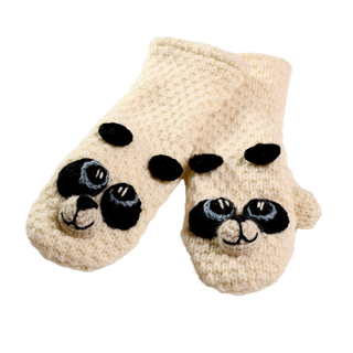 A pair of hand-made Crochet Panda Mittens from Nepal, cream-colored with black and white panda face designs on the front and small black ears on top. The mittens are showcased against a plain, solid black background.