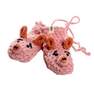 Introducing the Crochet Piggy Mittens: adorable pink knitted mittens with animal faces, featuring orange ears, black eyes, and embroidered noses. These sherpa-lined mittens are handmade in Nepal and come with a convenient pink string connecting them.