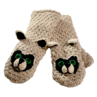 Introducing the Crochet Rockey Racoon Mittens, a pair of sherpa-lined wool mittens designed to resemble animal faces. These beige-colored crochet wool mittens feature distinctive black and white facial markings, green eyes, and small protruding ears on top. Handmade in Nepal, the mittens are displayed in an overlapping position.