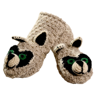 A pair of "Crochet Rocky Raccoon Mittens," handmade in Nepal, featuring a raccoon face design on the front with black ears and white paws. The mittens have green embroidered eyes and black nose accents.