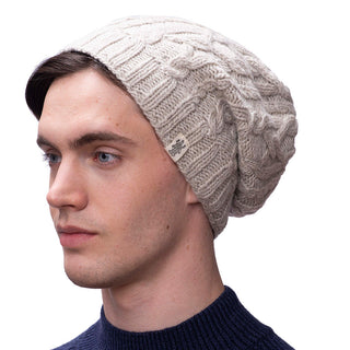 A man wearing an Alexander Cable Slouch winter hat.