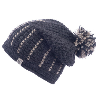 A handmade in Nepal Ferry slouch with a pom-pom and decorative stitch patterns on a white background.