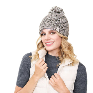 A woman wearing a Chunky pom beanie and vest.