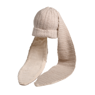 The Oversized Ear Beanie is a beige knitted hat featuring matching long, narrow, scarf-like attachments hanging from either side, lined with soft, cream-colored fabric on the interior. The background is plain white.