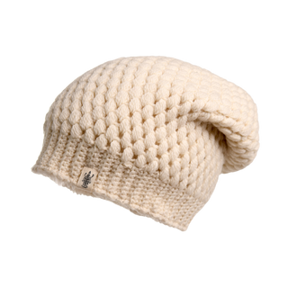 A cream-colored, chunky-textured winter beanie hat with a slouchy fit. This Bubble Hat features a small tag with an emblem sewn near the bottom edge, perfect for staying cozy and stylish.