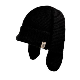 The Rib EarPup Hat is a black knitted hat featuring a wide brim and extended ear flaps, complemented by a small beige tag with a logo attached to the brim. The image of the hat has a transparent background.