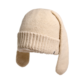 This is an image of the Rib EarPup Hat, showcasing its beige color and long ear flaps. The hat features a ribbed pattern around the edge and a smooth finish throughout the rest. The ear flaps hang down on both sides.