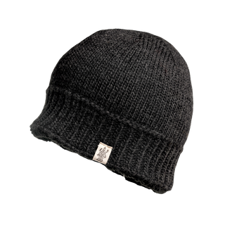 The Cabrini Hat is a black knitted beanie with a folded brim, adorned with a small white tag featuring a black design attached to it. This soft and slightly textured winter hat offers knit texture and comfort for colder days.