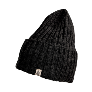 The Cooper Hat, a black, ribbed-knit beanie with a slightly pointed top, is shown. Crafted from premium merino wool, this winter essential features a folded cuff at the bottom and has a small fabric tag with a logo on the front. It’s stylish outdoor headwear perfect for chilly days.