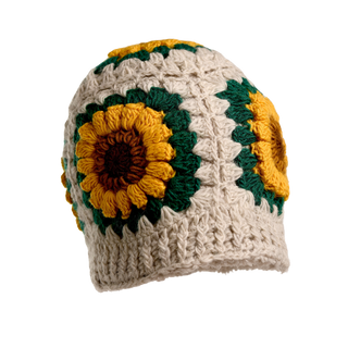 The Sunflower Sun Hat is a white crocheted beanie adorned with large sunflower patterns, featuring vibrant yellow petals, brown centers, and green leaves. Its intricate design incorporates various crochet stitches, adding texture and dimension to the hat.