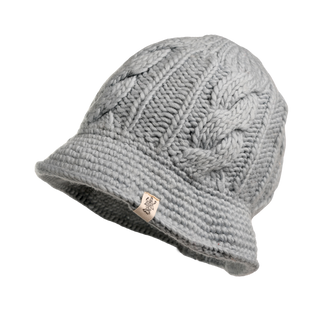 The Nostrand Hat is a gray cable knit hat featuring a folded brim and adorned with a small fabric tag displaying a logo. Crafted from soft merino wool, this essential piece enhances your winter wardrobe and is displayed on a plain black background.