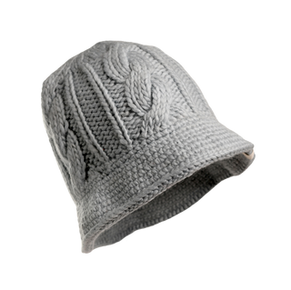 Introducing the Nostrand Hat: a gray, merino wool cable knit hat featuring a slightly flared brim and a rich, textured appearance from its intricately interwoven yarn strands. Perfect for your winter wardrobe, this stylish hat is showcased against a plain white background.