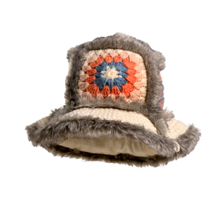 The Crochet Sun Hat With Fur Piping is a handcrafted, cream-colored hat perfect for cold-weather fashion, featuring a granny square crochet pattern in orange, white, and blue. The hat is outlined with gray faux fur piping for added texture.