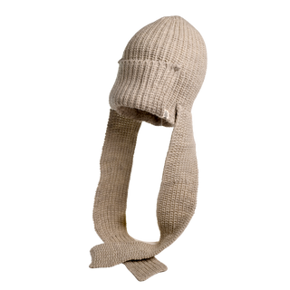 The Pelham Hat, handcrafted in Nepal using luxurious beige merino wool, showcases long scarf-like extensions on both sides. This hat features a textured, ribbed design and is displayed against a white background.