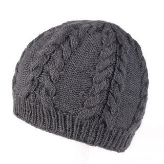 A charcoal gray Cable Beanie with a ribbed border and cable-knit pattern, handmade in Nepal.
