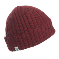 The Hand Knit Clyde Rib Fold Cap in dark red merino wool is displayed on a white background, featuring a ribbed knit, folded brim, and a small white rectangular tag.