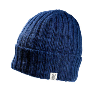 The Hand Knit Clyde Rib Fold Cap is a blue merino wool beanie with a ribbed knit, folded brim, and a small white logo tag on the front, shown against a white background.