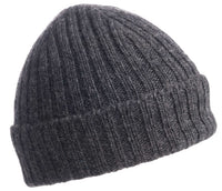 A Hand Knit Clyde Rib Fold Cap in dark gray features a ribbed-knit design and a textured, folded brim, photographed on a white background.