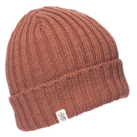 The Hand Knit Clyde Rib Fold Cap is a brown merino wool beanie with ribbed knit, a folded brim, and a small white tree-tag, displayed against a white background.