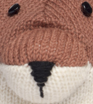 Close-up of a Hand Loom Fox Hat, a brown and cream knit hat featuring button eyes and a black stitched nose.