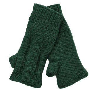 The Cable Handwarmers are dark green, knitted Merino wool fingerless gloves with a textured cable pattern and thumb openings, shown flat and overlapping on a white background—perfect winter gloves for women.